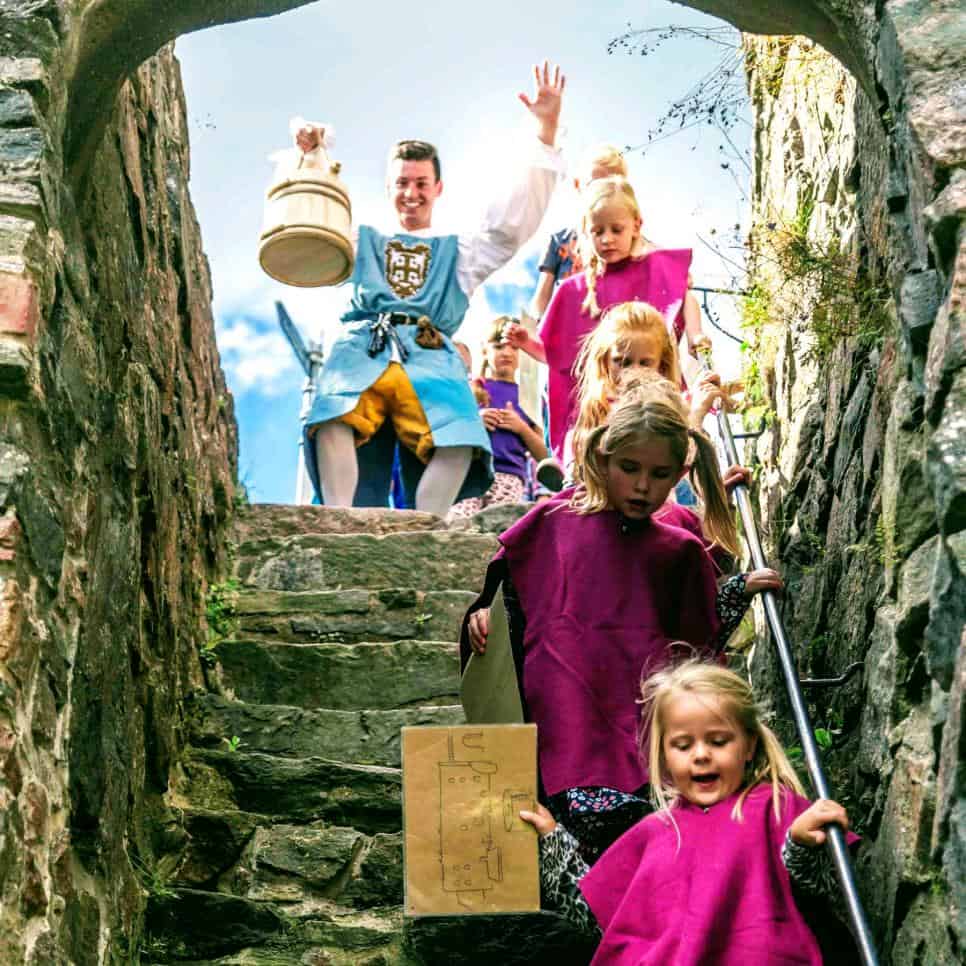 happy children on stone stairs during children's party at bohus fortress